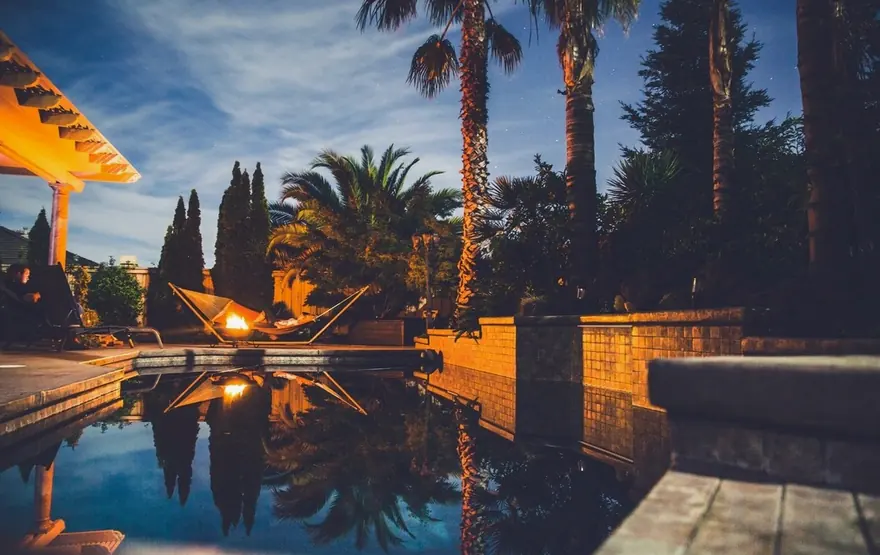 A pool lit up in the evening
